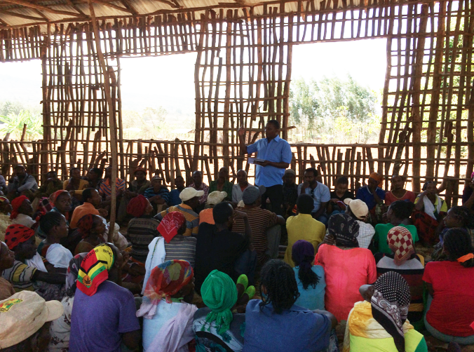 Biruk leading the General Assembly in Dubano Bulo that resulted in the legal incorporation of the women savers into the Dubano Bulo Grain Marketing Cooperative.