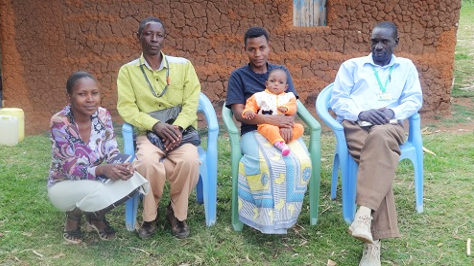 Rose Paul at her home with her baby and Nuru Kenya Healthcare staff