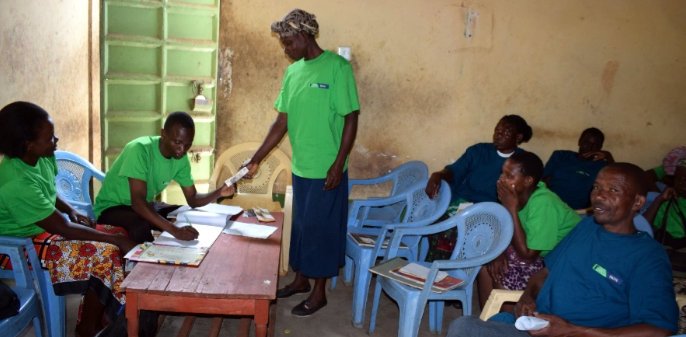 A section of members of one of the Chama Solutions Group in a group meeting at Nyankore Village, Migori County.