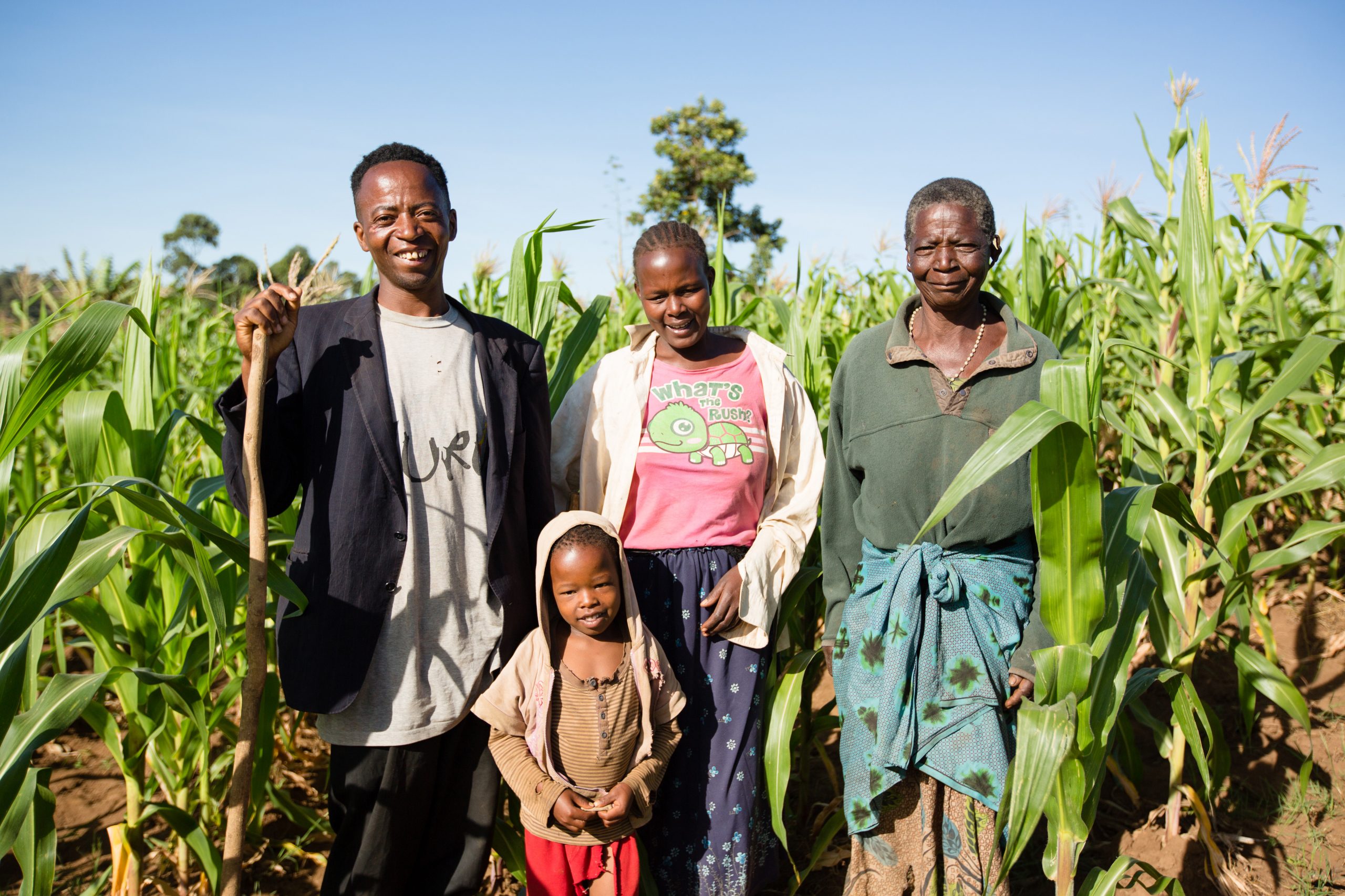 Kenyan family standing in field 