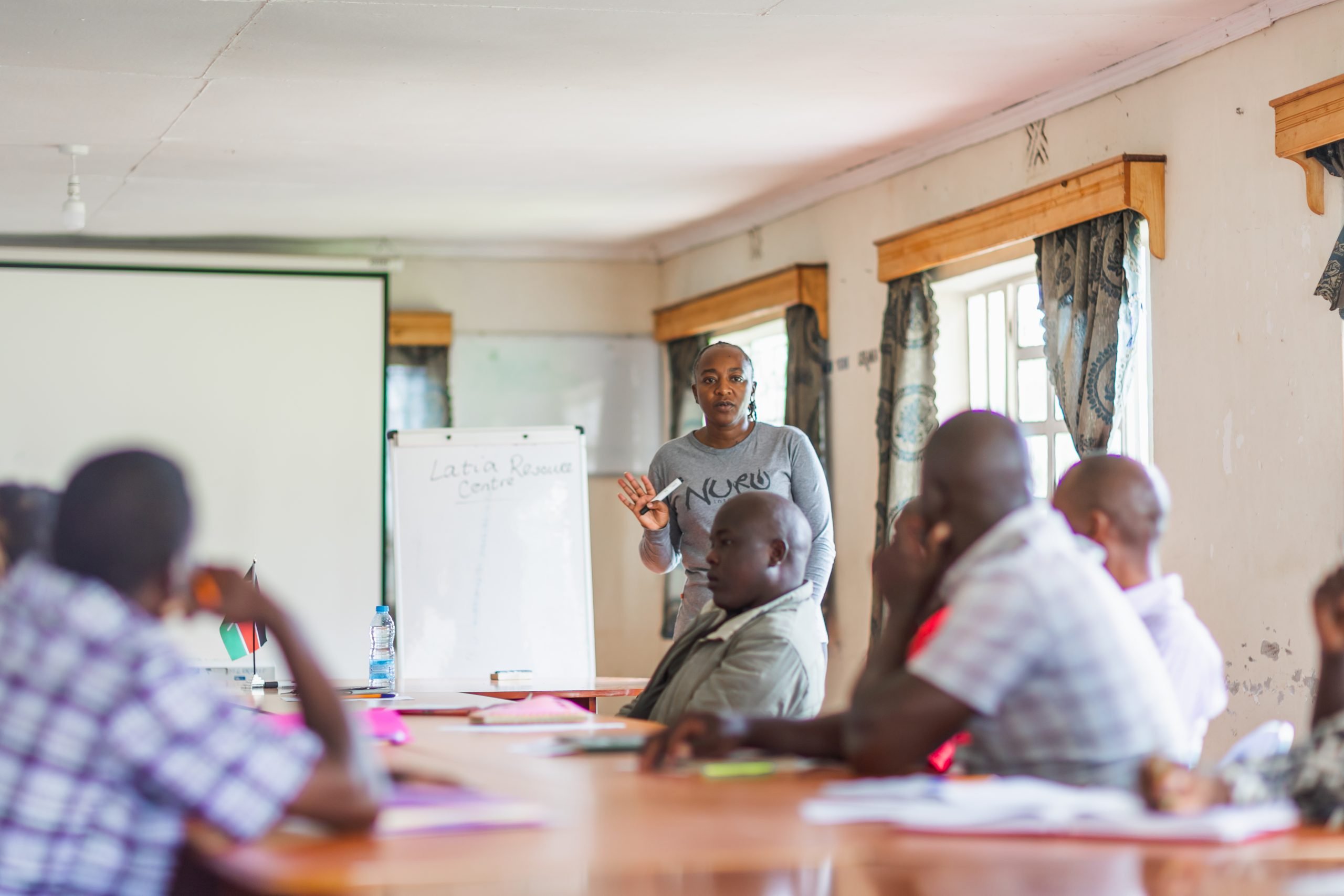 woman leading meeting in conference room in Kenya