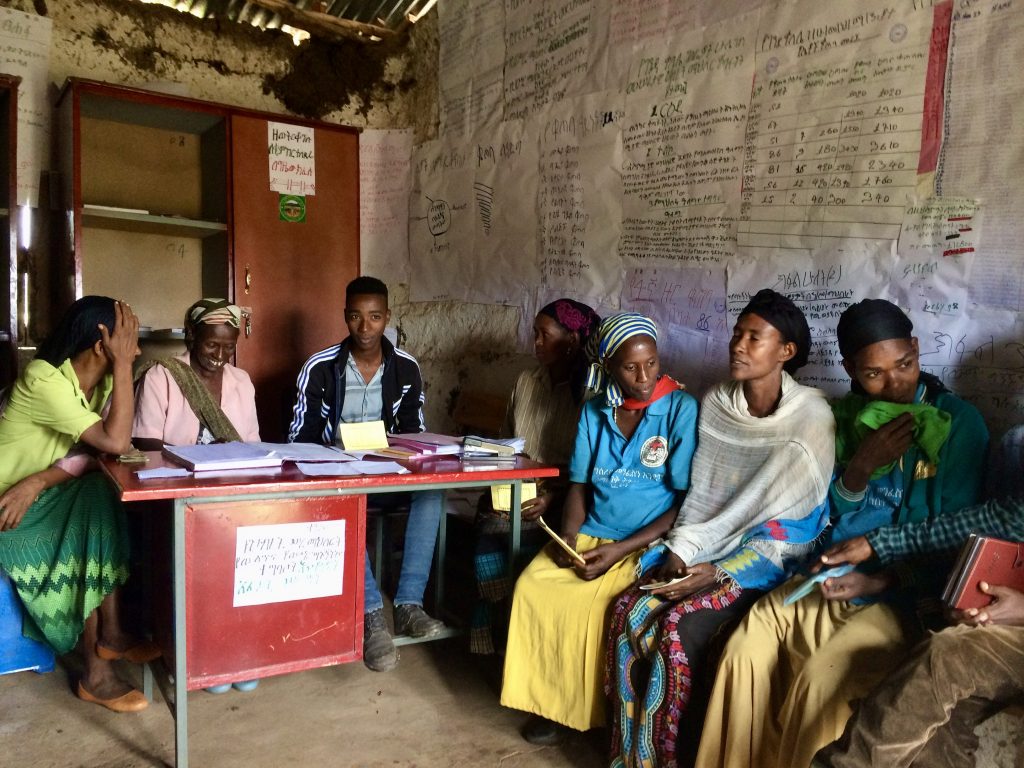 group of people sitting together in a room 