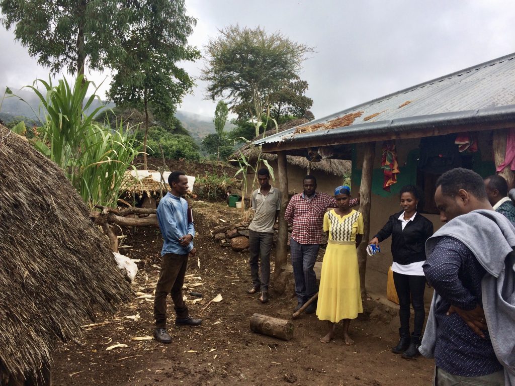 group of people standing outside home in Ethiopia