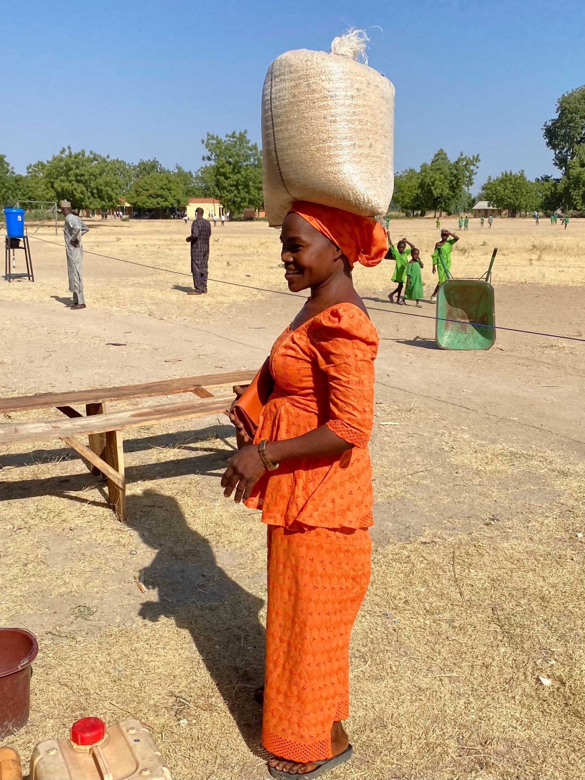 woman carrying grain on her head