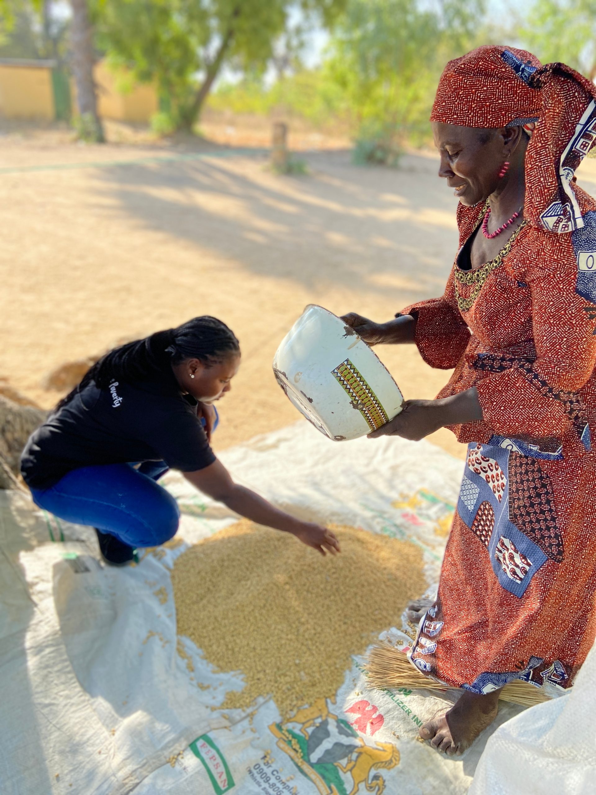 women separating grain outside