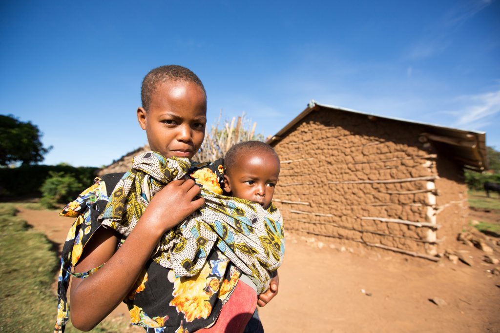 mother and child in front of building