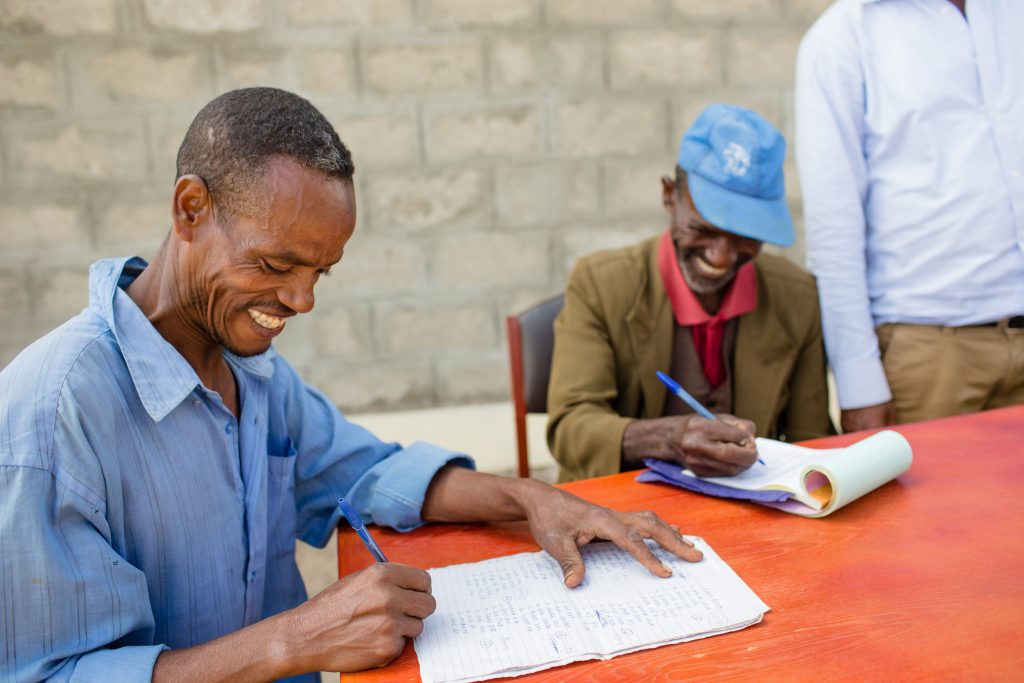 farmer members gathered around a table smiling