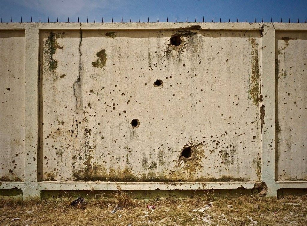 outer wall of building with bullet holes 