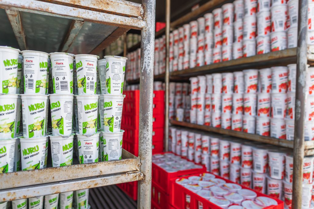 individual yogurt containers on shelves made from farmers' cow milk 