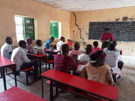 Nigeria - woman leads training for group of people in classroom 