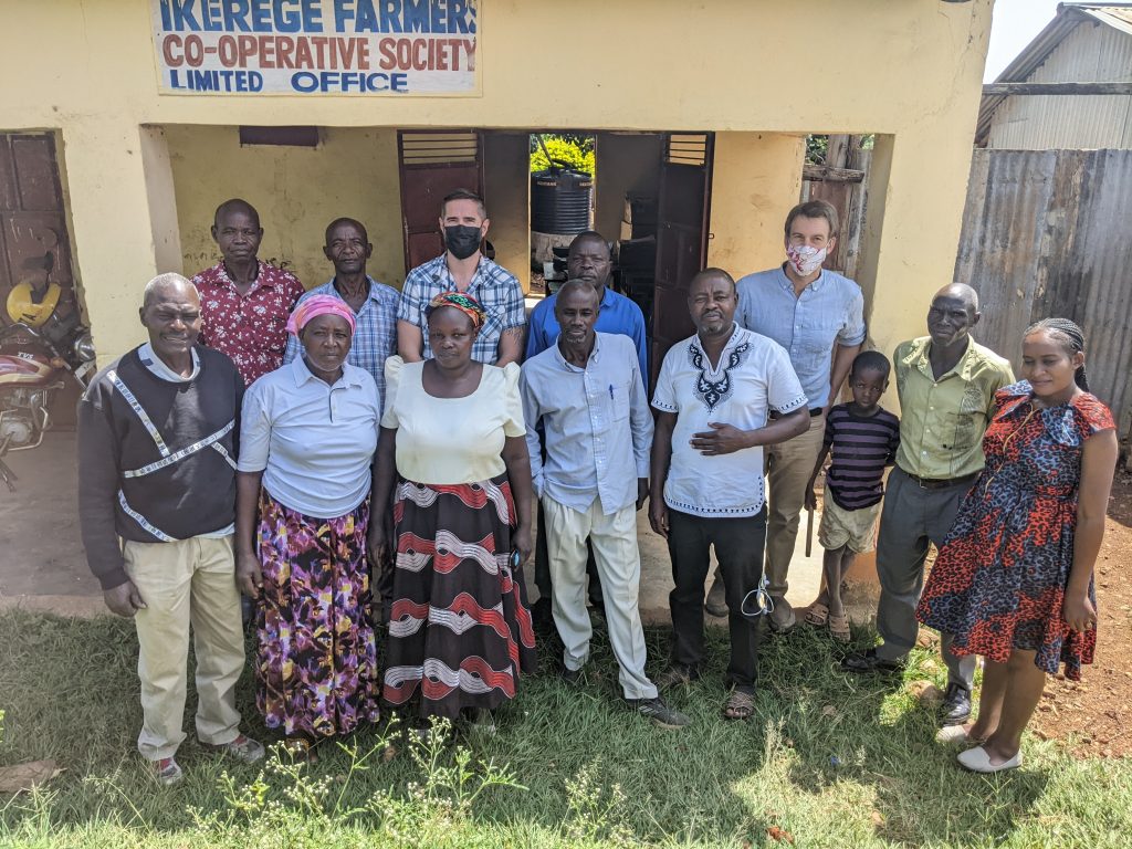 group of people standing outside farmer cooperative building