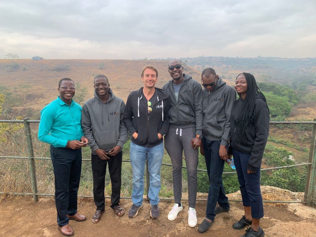 group of people standing together in Kenya and smiling