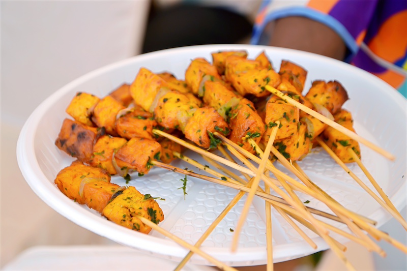 a plate with skewers of fried tofu 