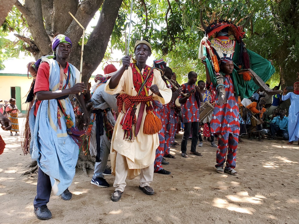 group of people in northeast Nigeria dancing during a traditional celebration outdoors