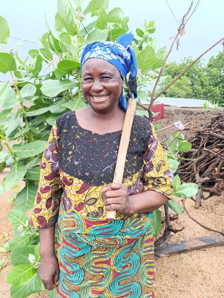 woman farmer standing outside and smiling at the camera 