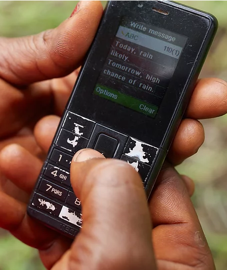 hands holding a mobile phone with ignitia weather service technology displayed