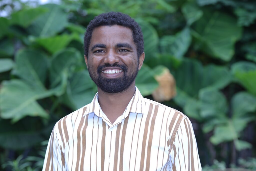 man standing outside and smiling at the camera