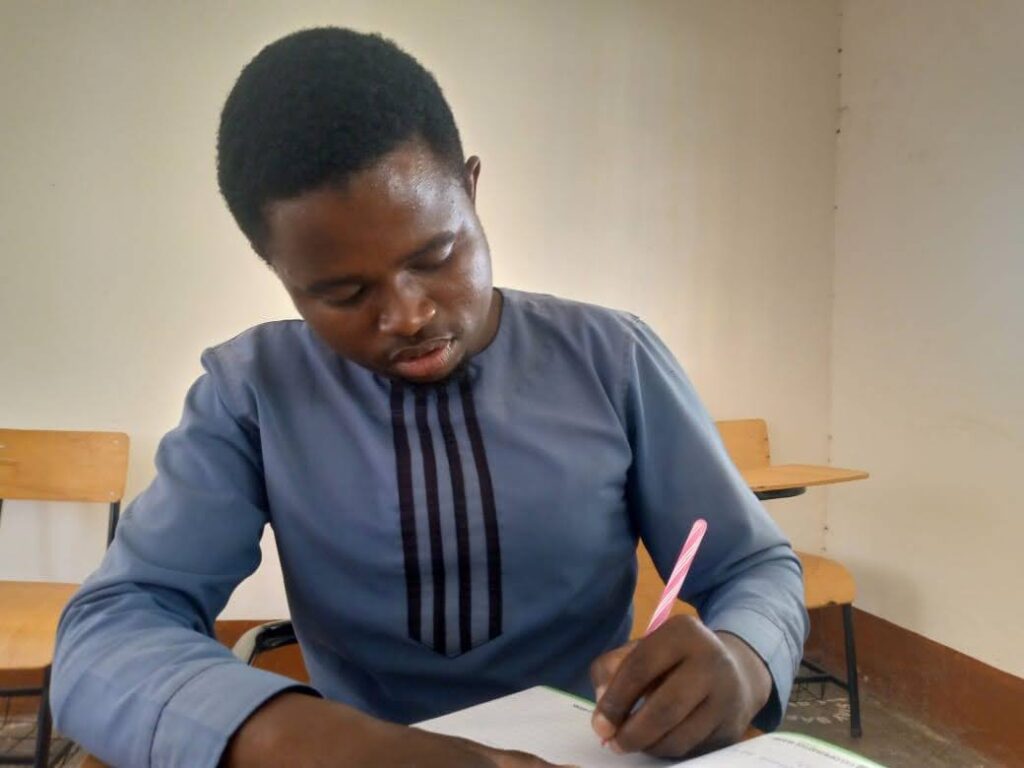 man seated at a desk and working on an assignment at NRTC